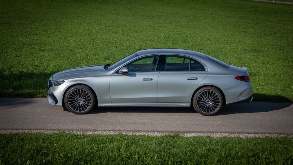 Foto der Seitenansicht einer Mercedes E-Klasse vor einer grünen Wiese